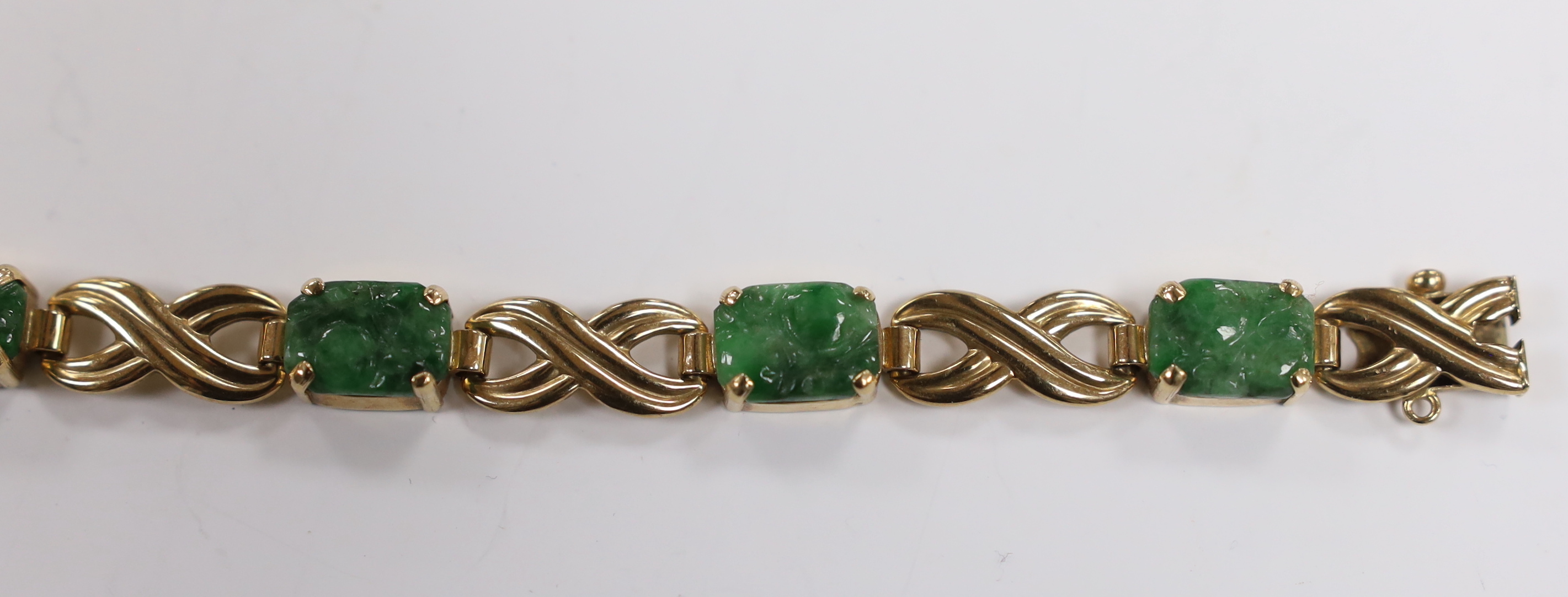 A 1960's 9ct gold and six stone carved jade panel set bracelet, by Cropp & Farr,17cm, gross weight 15.2 grams.